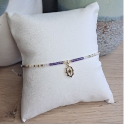 Bracelet fin violet/blanc/doré avec breloque ovale étoile du nord