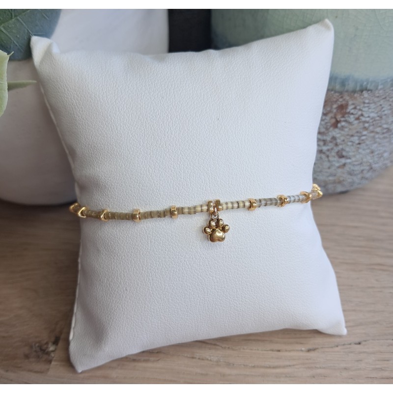 Bracelet fin beige scintillant avec breloque patte